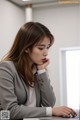 A woman sitting at a desk using a laptop computer.