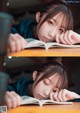 A young woman is reading a book while sitting at a table.