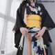 a woman wearing a black and yellow kimono