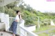 A woman standing on a balcony talking on a cell phone.